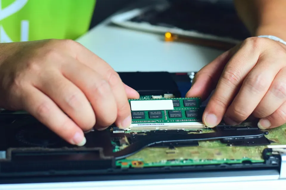 a-technician-swapping-the-ram-in-a-laptop5